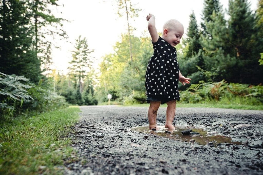 You Child Playing in a muddy puddle