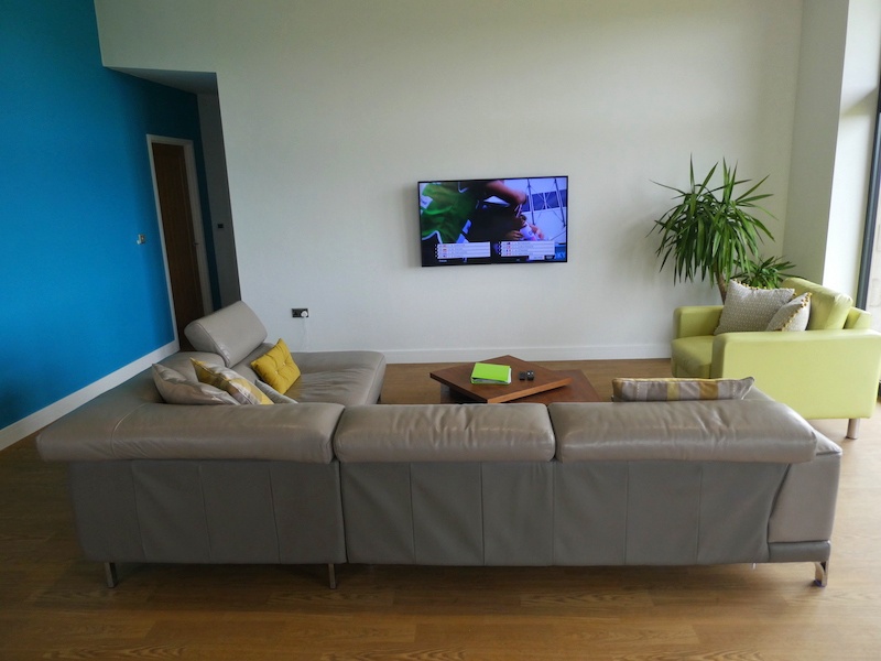 picture of the sitting area from behind the sofa facing the television